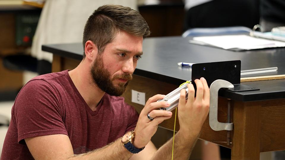 Student completing a physics experiment